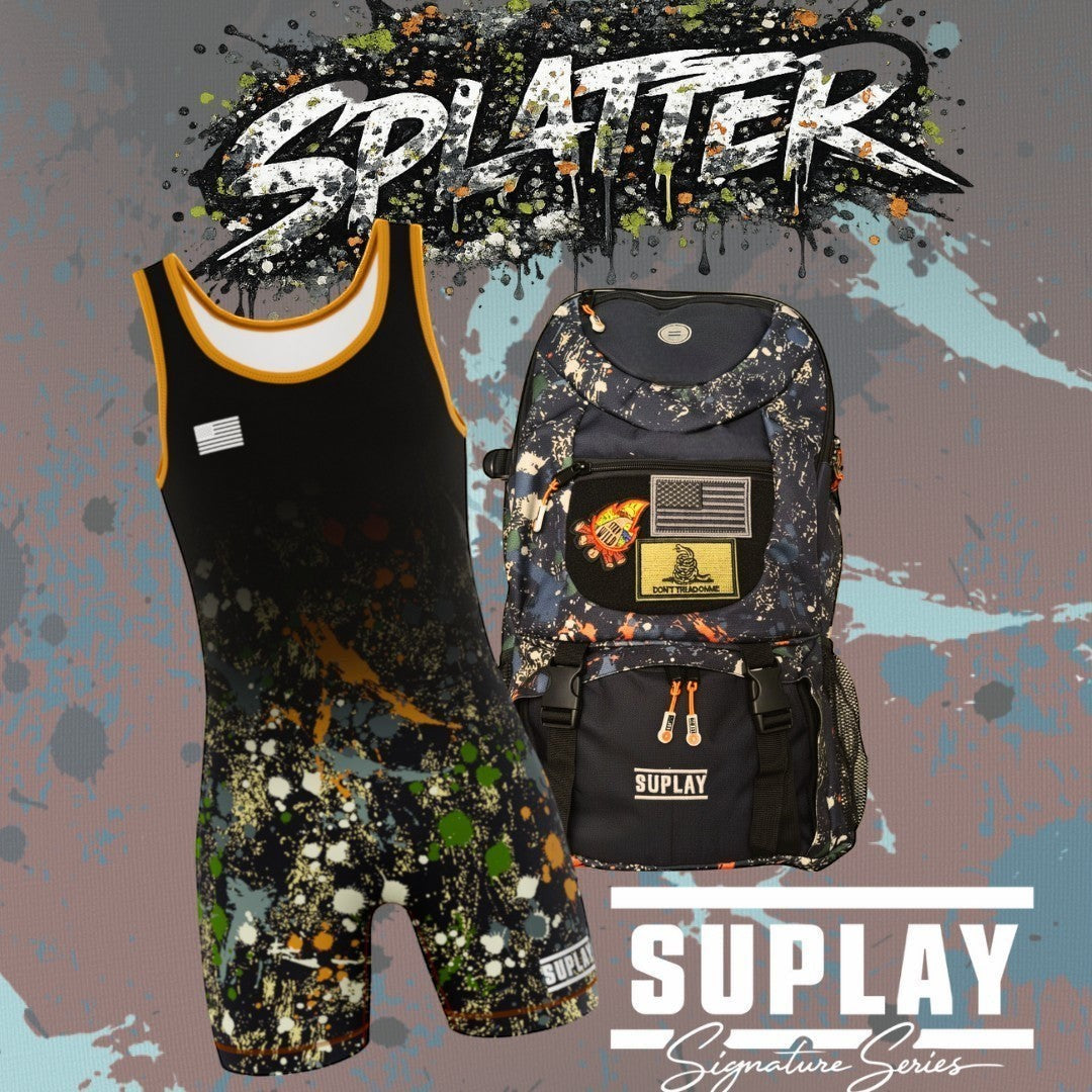 Suplay.com Signature Series wrestling singlet and matching gear bag with a black and multi-color paint splatter design.